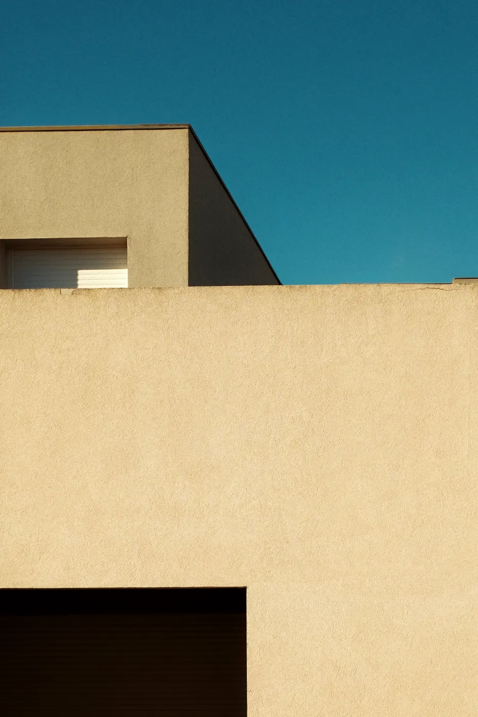 Smooth rendered wall against a deep blue sky