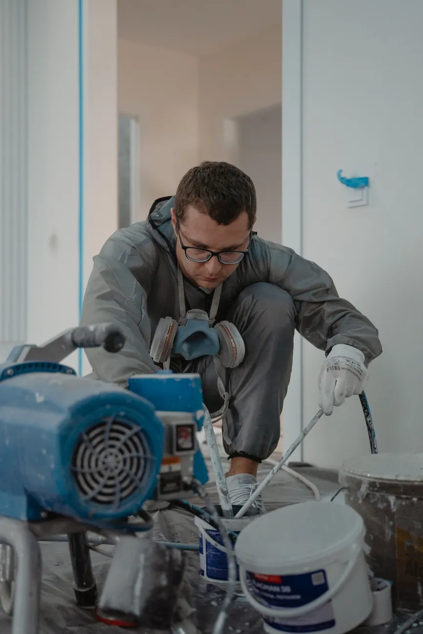 Painter preparing an airless spray machine