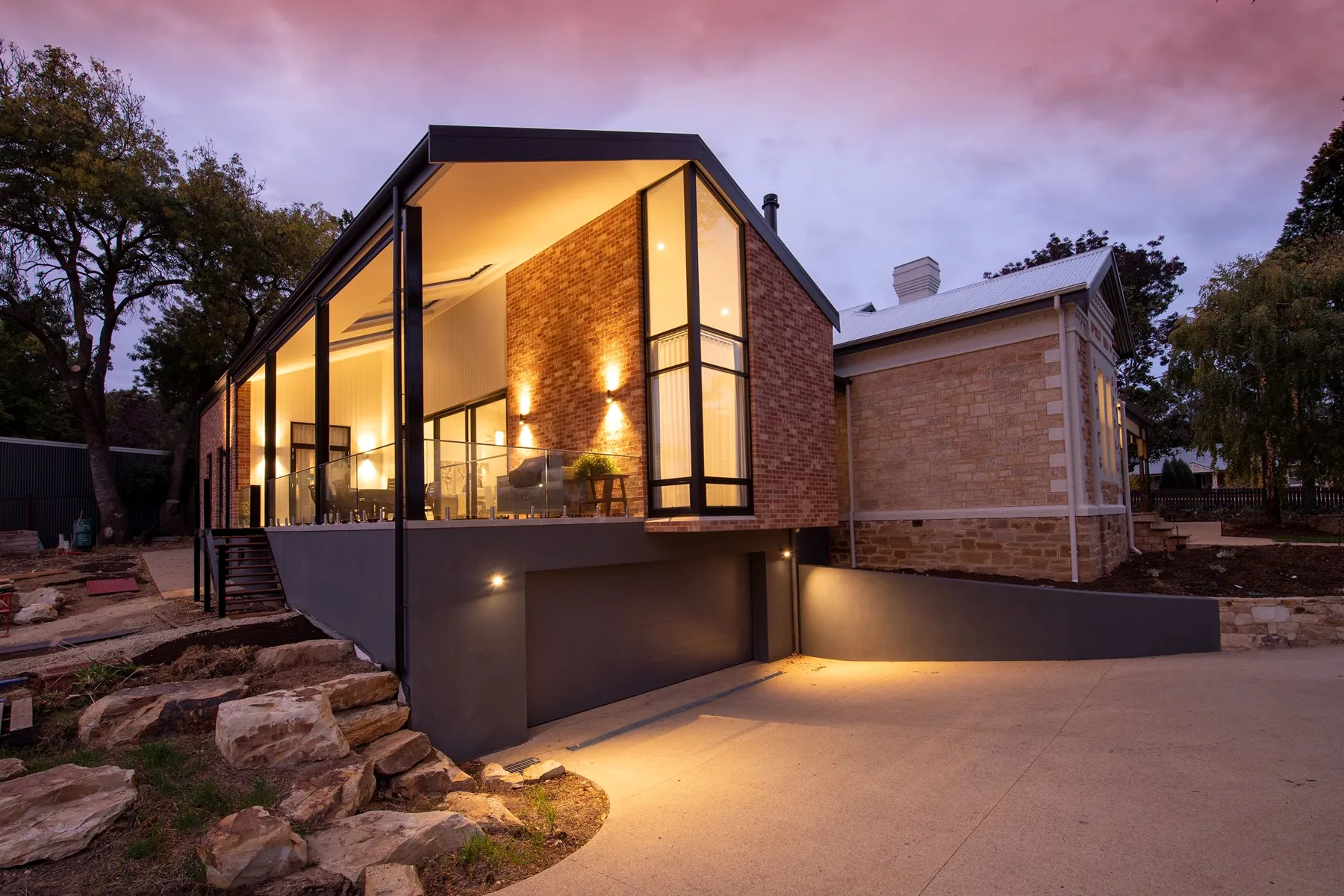 Contemporary family home lit at dusk
